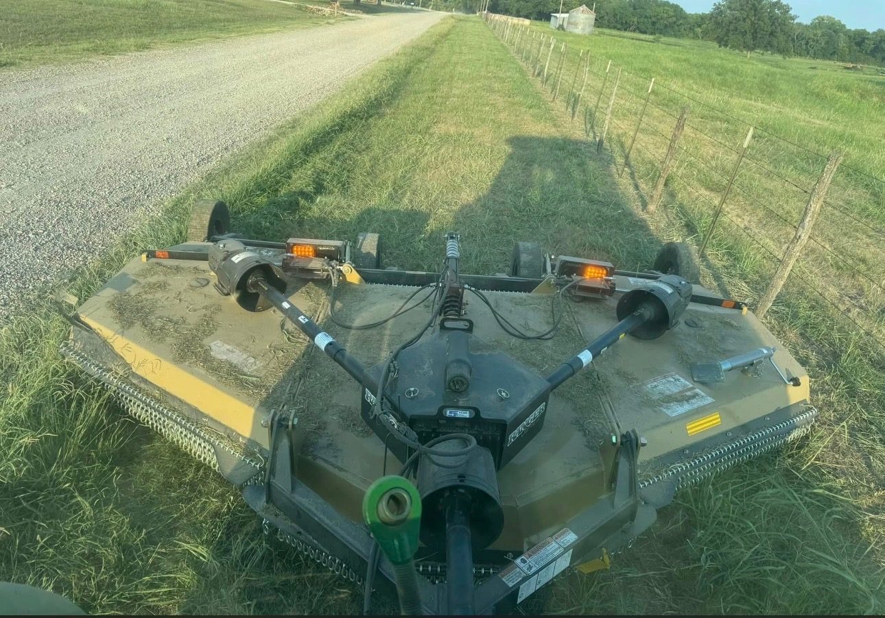 Pasture mowing along fence line