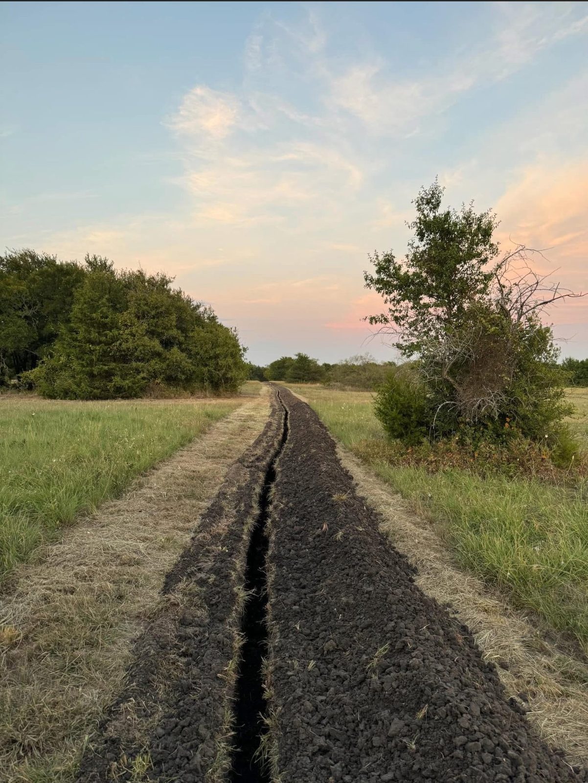 Trenching trench at sunset
